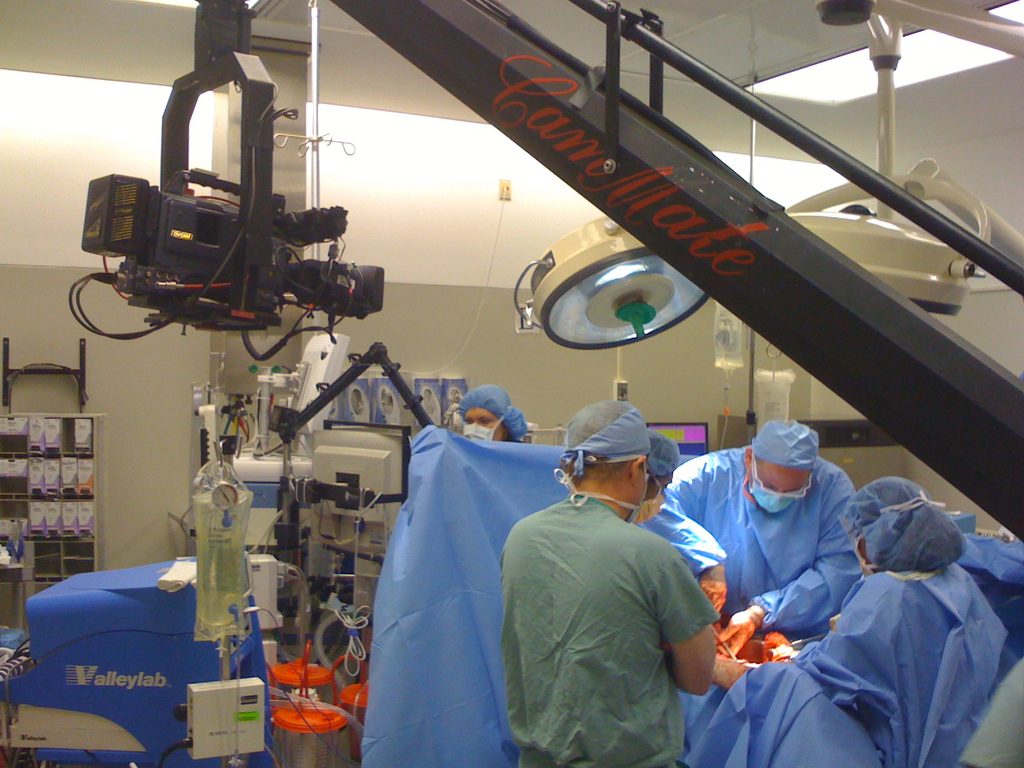 CamMate crane holding a broadcast camera over a surgical team in an operating room.